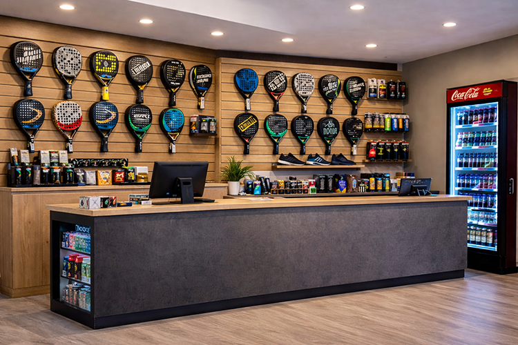 waiting area and reception in a padel club with racket display